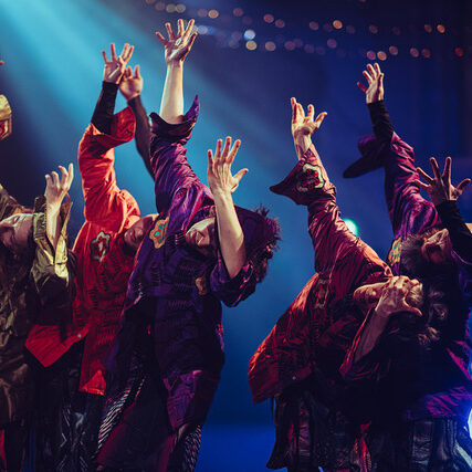 Dancers with arms raised