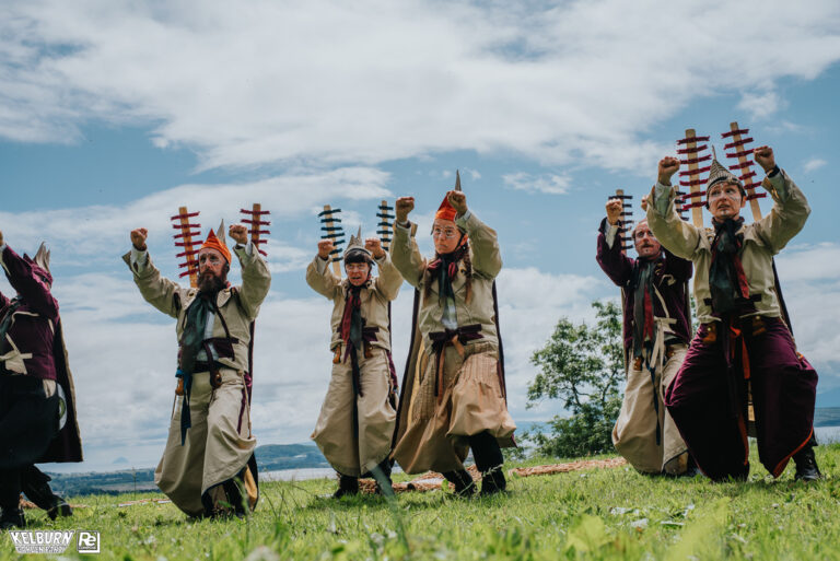 Costumed dancers in a field